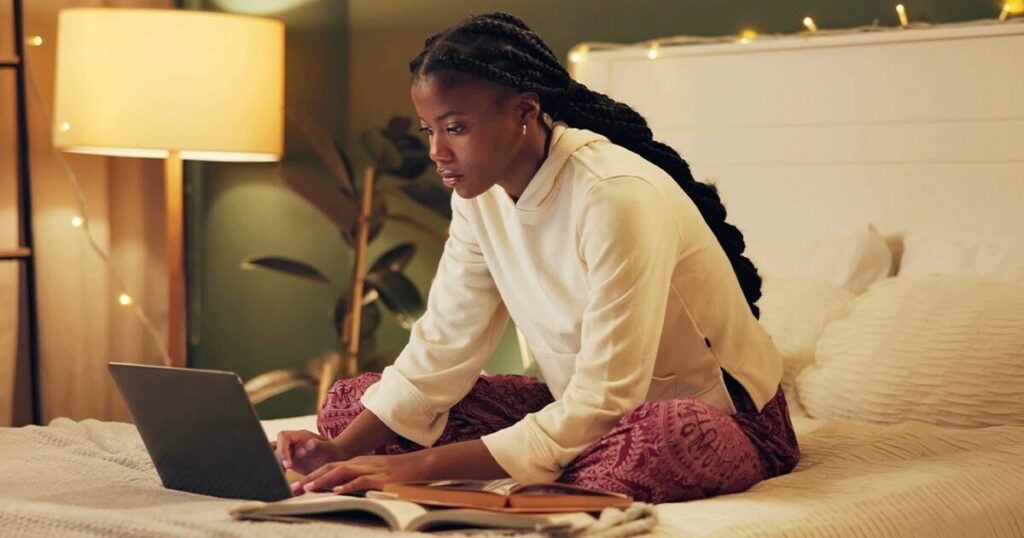 Woman researching information about the abortion pill on her laptop at home